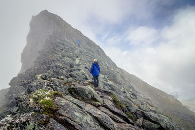 Two people walking on rocky landscape