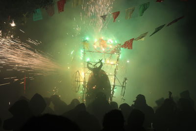 Silhouette people enjoying at night