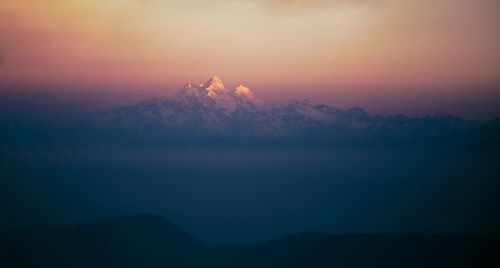 Scenic view of silhouette mountains against sky during sunset