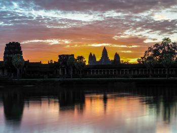 Reflection of building in water at sunset