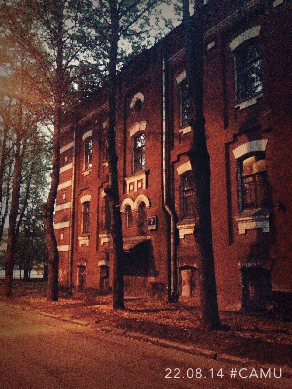 architecture, building exterior, built structure, tree, bare tree, text, street, building, window, outdoors, transportation, no people, road, residential building, western script, day, house, residential structure, city, communication