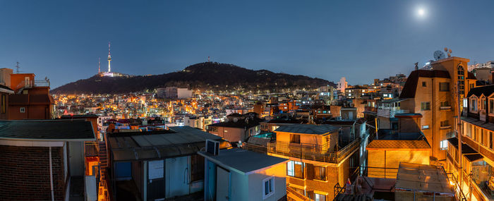 High angle view of illuminated buildings in city at night