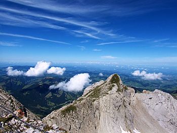 Panoramic view of rocky mountains against blue sky