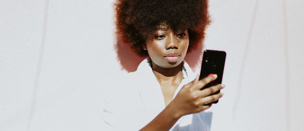 Midsection of woman using mobile phone