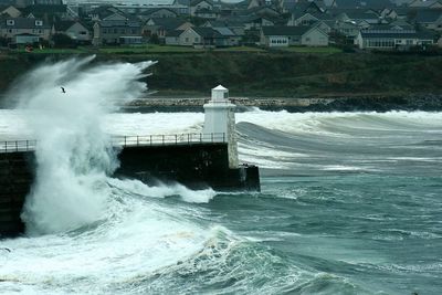 Wave crashing against lighthouse