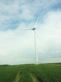 Windmill on field against sky