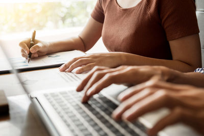 Midsection of man using mobile phone