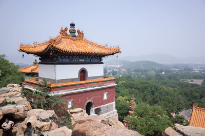 High angle view of man and boy walking by temple