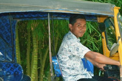Portrait of young man driving jinrikisha