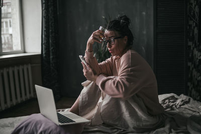 Midsection of woman using mobile phone