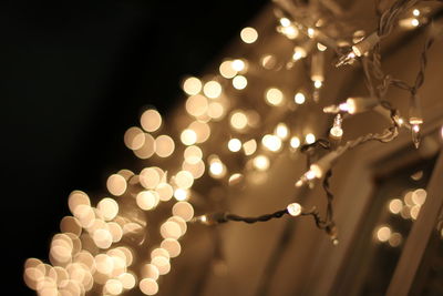 Close-up of illuminated string lights during christmas at night