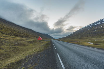 Road amidst mountains against sky