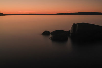 Sunrise over calm water - lysaker