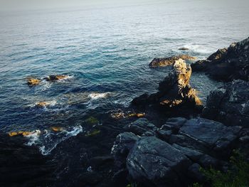 High angle view of rocks by sea