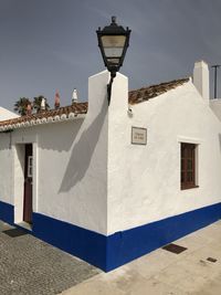 Low angle view of street light against building