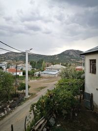 Street by buildings against sky