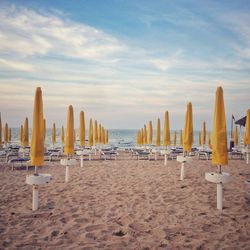 Panoramic view of row on beach against sky