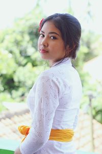 Portrait of young woman standing outdoors