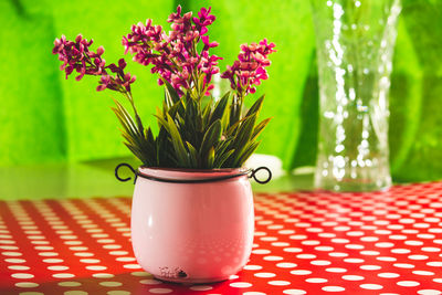 Close-up of red flower vase on table