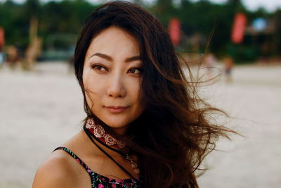 Portrait of young asian woman with long hair in wind