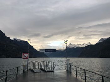 View of sign by sea against sky