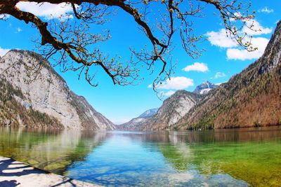 Scenic view of lake and mountains against blue sky