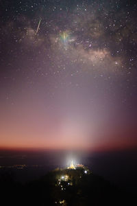 Low angle view of star field against sky during sunrise