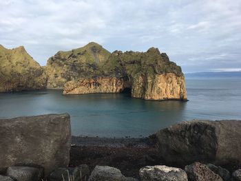 Scenic view of rocks in sea against sky