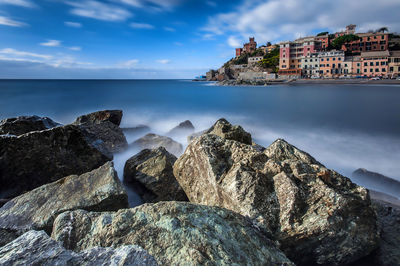 Panoramic view of sea and buildings against sky