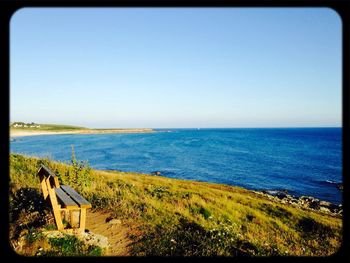 Scenic view of sea against clear blue sky