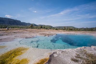 Scenic view of land against cloudy sky