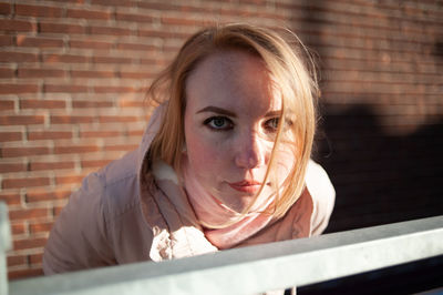 Portrait of woman against wall