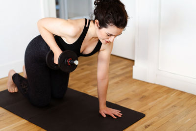 Full length of woman exercising in gym