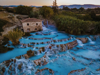 Scenic view of waterfall against sky