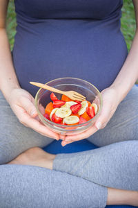 Low section of woman eating food