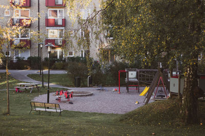 View of playground against trees and buildings