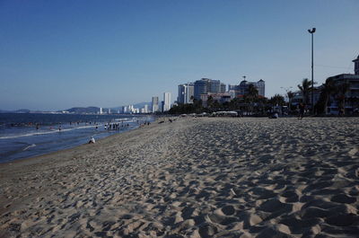 Scenic view of beach against clear sky in city