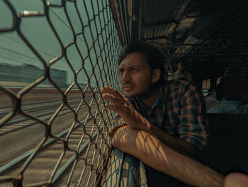 Young man looking out of the train window 