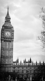 Clock tower against cloudy sky