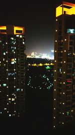 Illuminated cityscape against sky at night