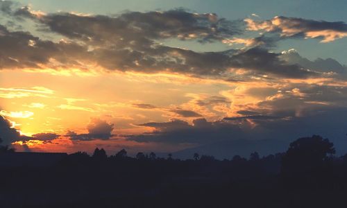 Scenic view of silhouette landscape against sky at sunset