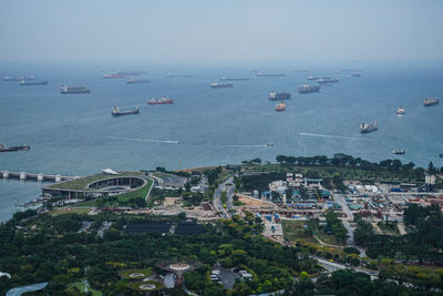 High angle view of townscape by sea against sky