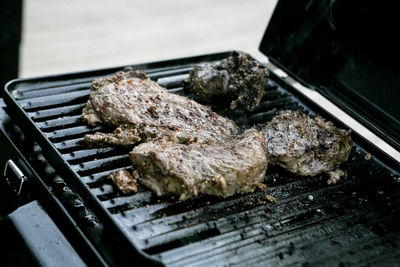 High angle view of beef cooking on barbecue grill