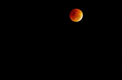 Low angle view of moon against clear sky at night