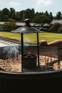 Cropped hand of person burning incense