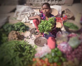 Full length of woman sitting in container