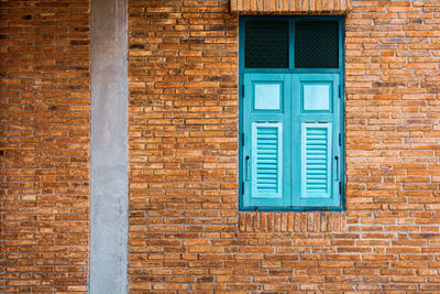 Full frame shot of window on brick wall of building