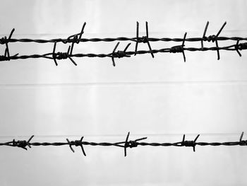 Barbed wire fence against sky