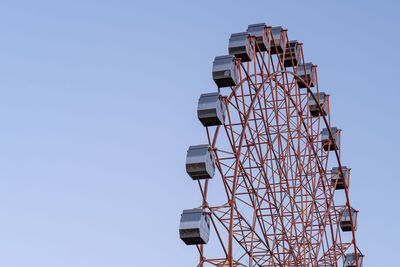 Low angle view of electricity pylon against clear sky