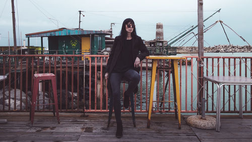 A woman sitting in a sea front place